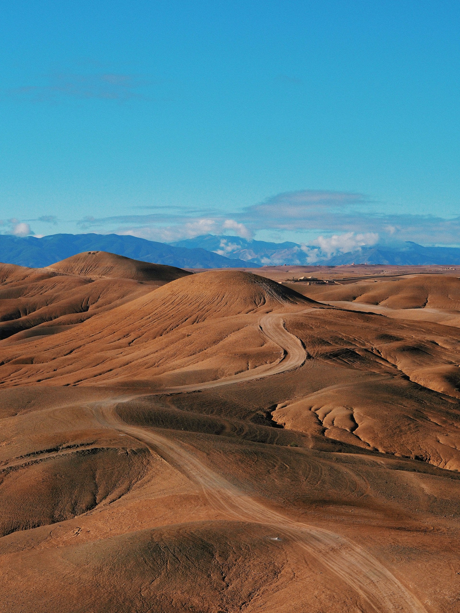 Stony Agafay Desert landscape with mountains in the distance near Marrakech