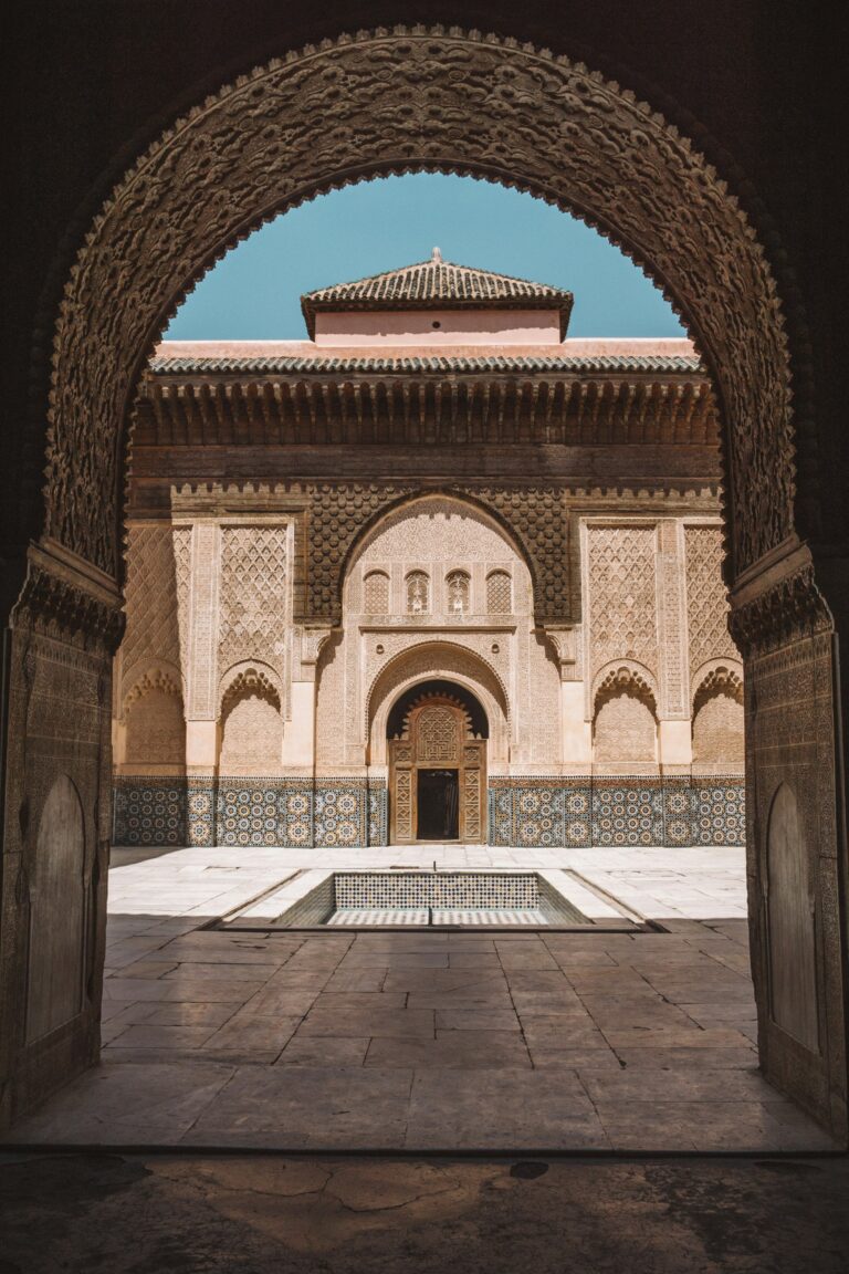 Courtyard of the Ben Youssef Madrasa in Marrakech with carved stucco and zellige