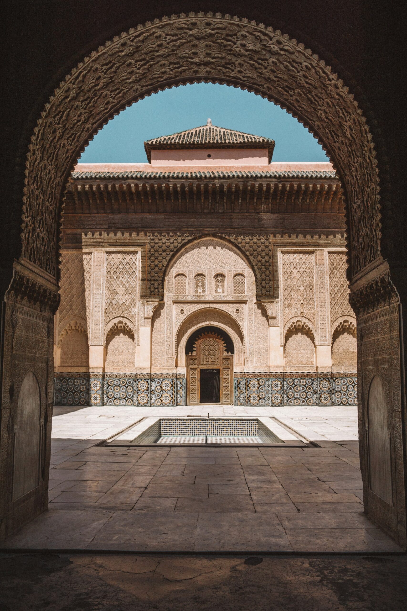 Courtyard of the Ben Youssef Madrasa in Marrakech with carved stucco and zellige