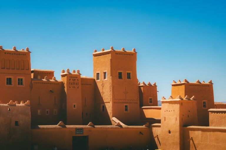 Ancient earthen kasbah fortress under a clear blue sky