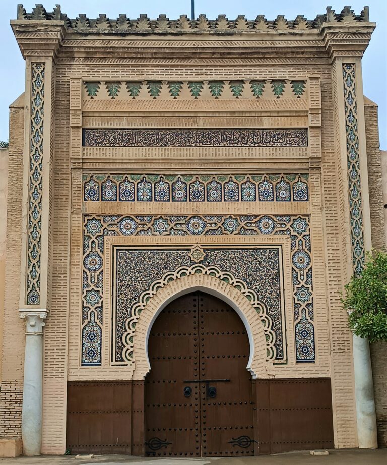 Monumental gate with a large wooden door in the imperial city of Meknes