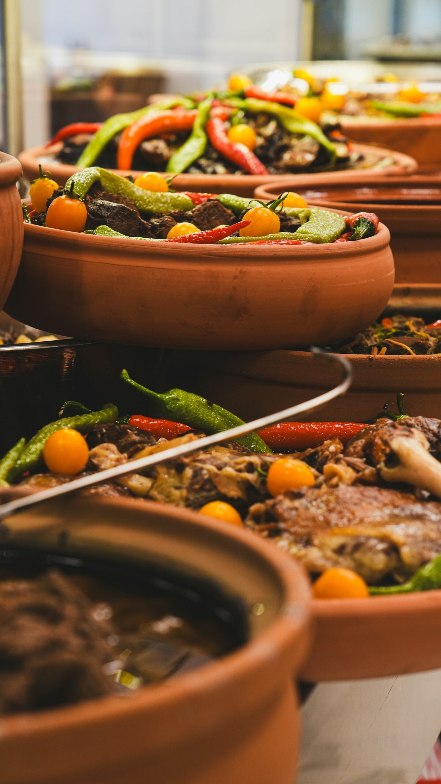 Clay tagine pots filled with slow-cooked meat and vegetables