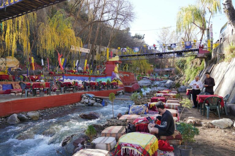 Travelers at a riverside table in the Ourika Valley