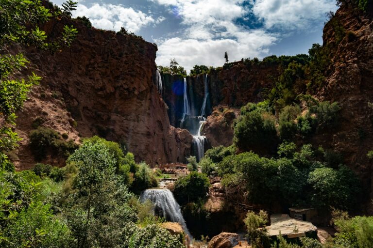 The Ouzoud Waterfalls cascading down rocky cliffs surrounded by greenery